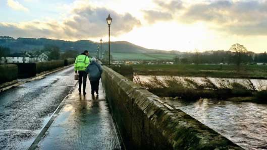 environment agency worker with elderly person