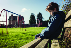 sad child alone in playground